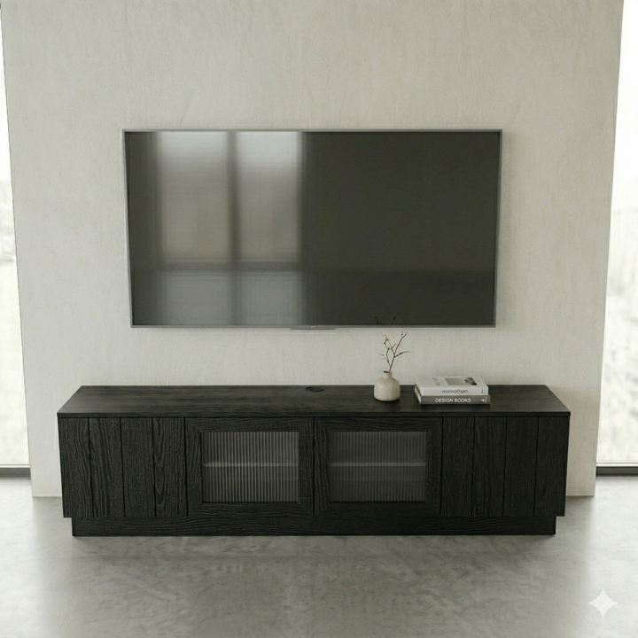 Black entertainment console with a TV above it in a minimalistic room.